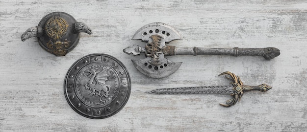 viking weapon on white wooden background