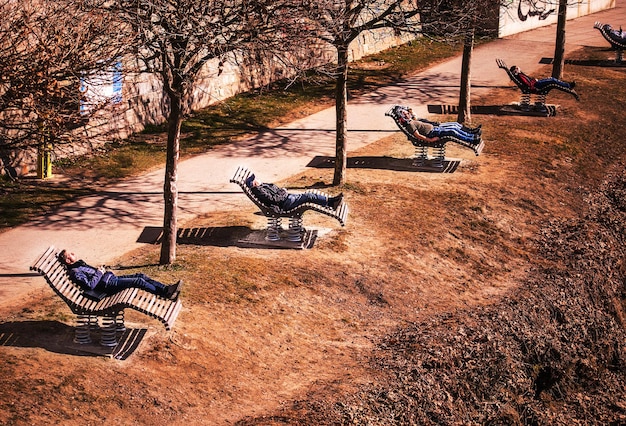 Villach Austria February 23 2023 Walk around the city people resting on wooden deck chairs along the banks of the Drava River