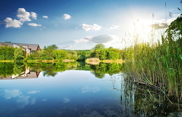 Village by the calm river in spring