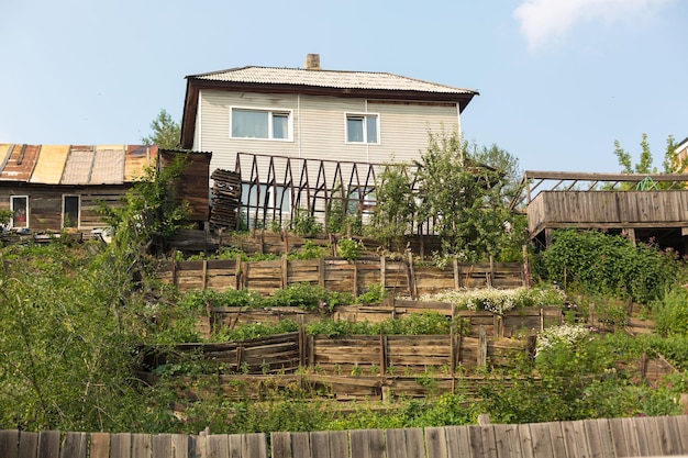 A village house on a mountain with multilevel plots for growing vegetables