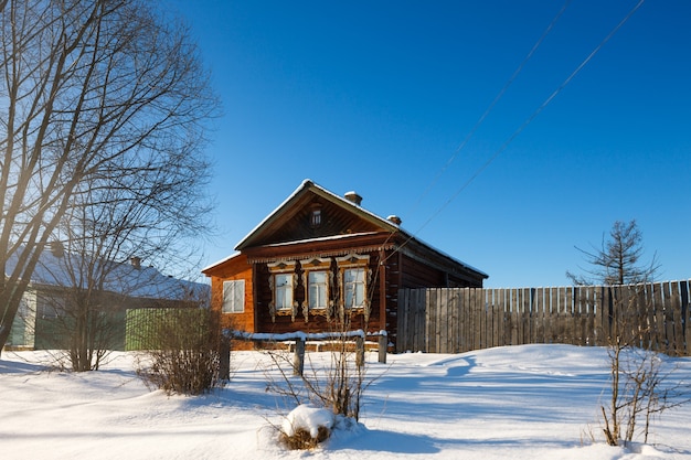 Village house with frozen windows on a cold winter day