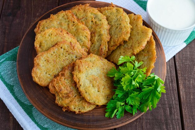 Village vegetarian pancakes made from potatoes in a clay bowl. The top view