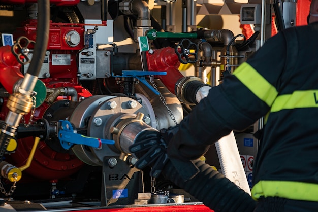 VILLANOVA DEL GHEBBO, ITALY 23 MARCH 2021: Firefighters pump water