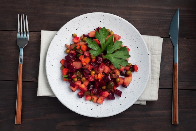 Vinaigrette with beetroot and boiled vegetables traditional Russian homemade salad Dark wooden background copy space