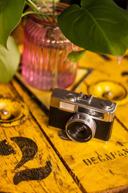 Vintage analogue camera on a rustic wooden yellow table