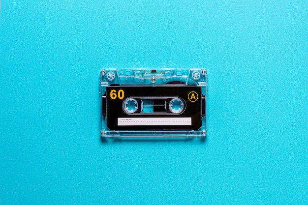 Vintage audio cassette tapes on blue wall.