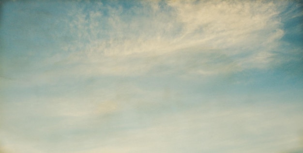 Vintage background in the blue sky with clouds