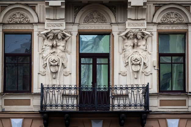 A vintage balcony decoratind with beautiful cariatides in Saint Petersburg, Russia