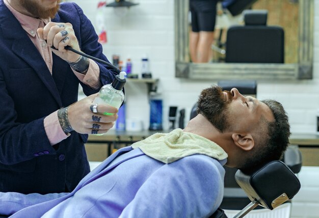 Vintage barber shop shaving. Bearded man. Beard care. Master hairdresser.