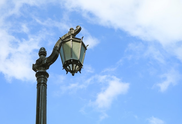 Vintage Black Lamppost Against Cloudy Blue Sky