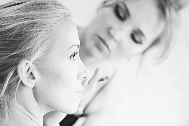 vintage black and white photo of a girl with professional make-up / strict make-up on the face of a beautiful professional model in a beauty salon