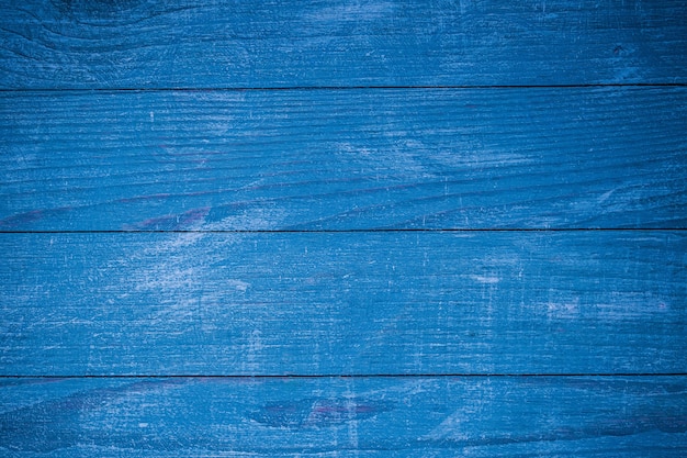 Vintage blue wood background texture with knots and nail holes. Old painted wood wall.