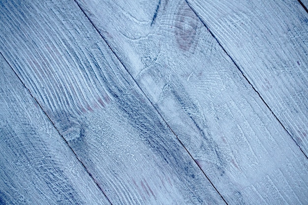 Vintage blue wood background texture with knots and nail holes. Old painted wood wall.