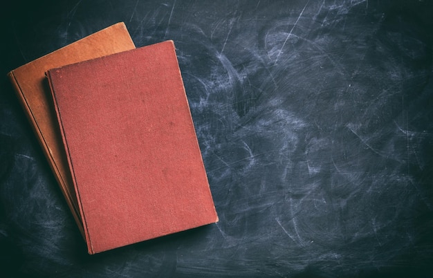 Vintage books on a blackboard copy space