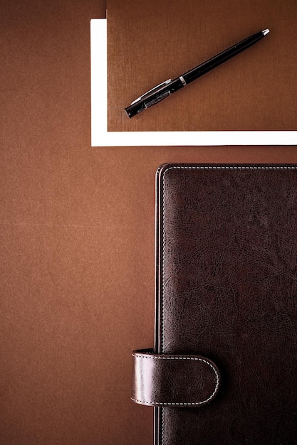 Vintage business briefcase on the office table desk flatlay background