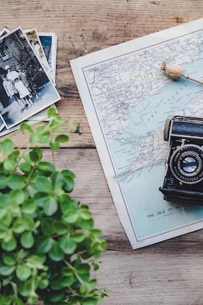 a vintage camera sits on a table next to a map