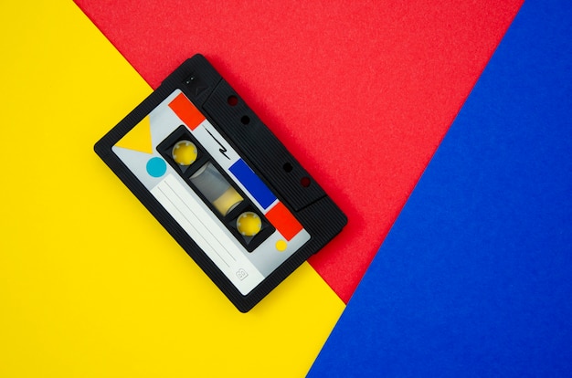 Photo vintage cassette tape on vivid background with copy-space