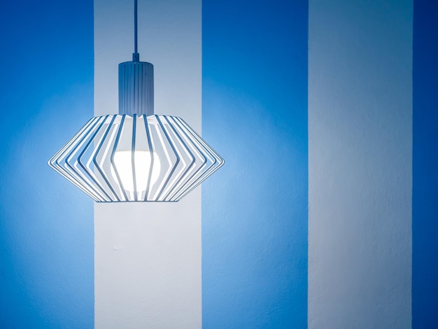 Vintage ceiling lamp on white and blue wall background