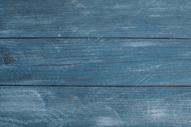 Vintage colored wood background texture with knots and nail holes.