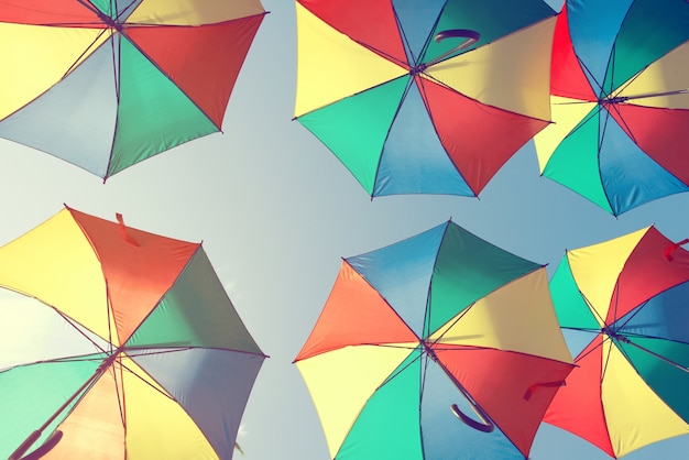 Vintage colorful umbrella on side beach - festival party in summer