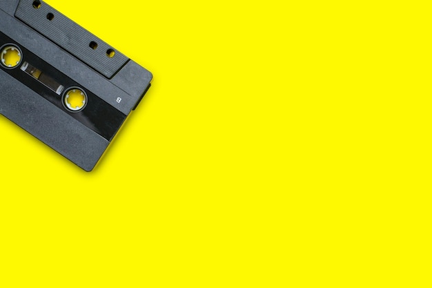 Vintage compact cassette tape on yellow background