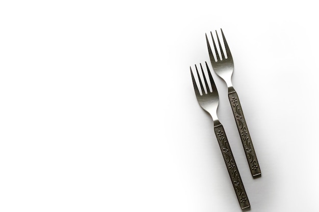 Vintage engraving silverware fork set of two placed side by side isolated on white background