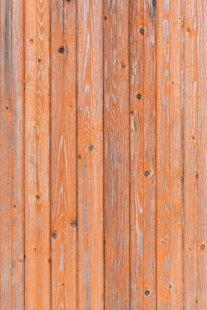 Vintage fence of old wooden boards Texture of an aging wooden surface Beautiful wooden background