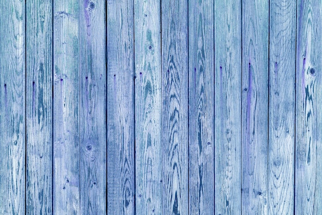 Vintage fence of old wooden boards Texture of an aging wooden surface Beautiful wooden background