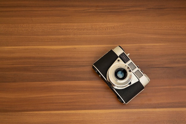 Vintage film camera on wood background