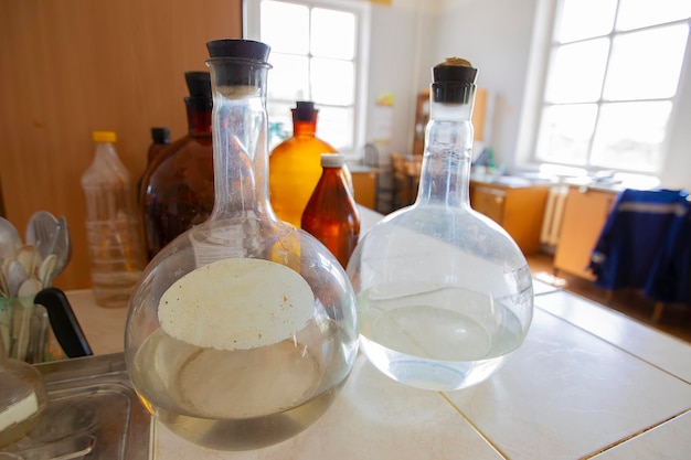 Vintage flasks on a laboratory backgroundGlass retro test tubes on the table