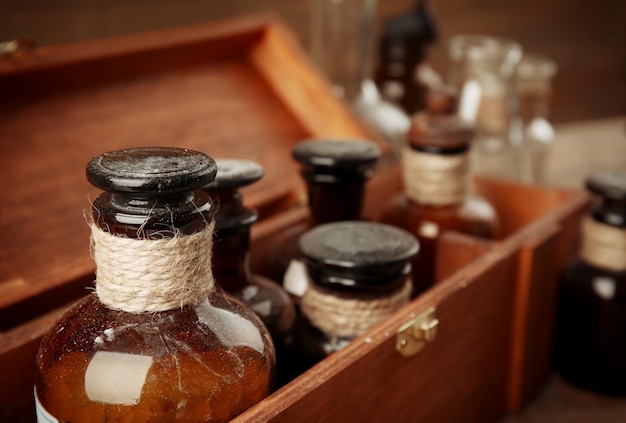 Vintage glass bottles in wooden box closeup