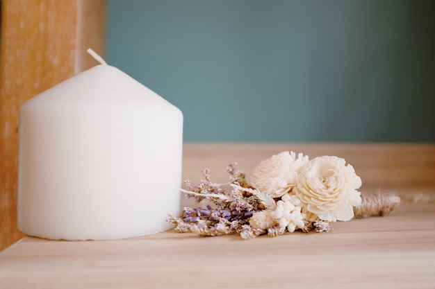 Vintage holiday decor, pine and burning candles on an old wooden for wedding decoration.