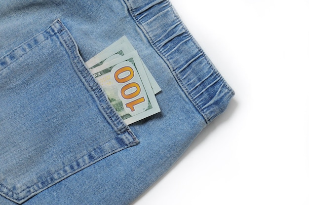 Vintage jeans with money in pocket close up on isolated white backgroundxDxA