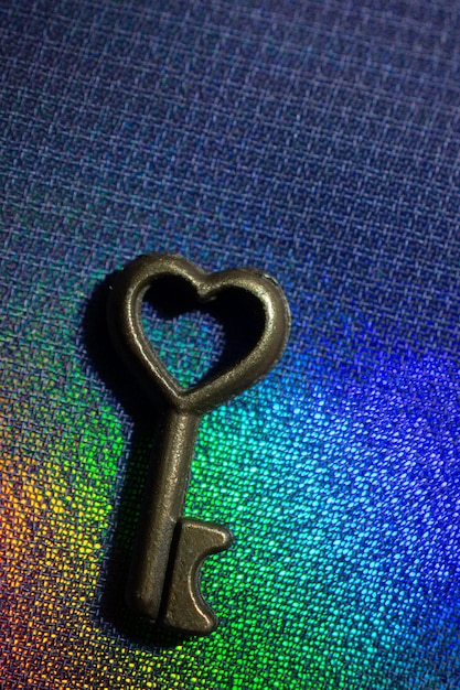 Vintage key Antique key Retro key with a heart shape on on colorful fabric