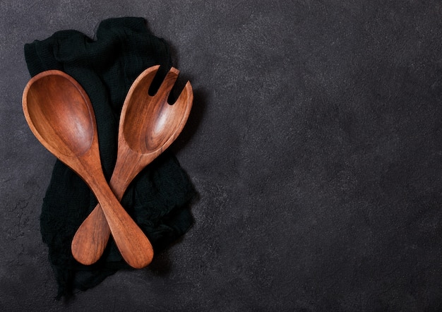 Vintage kitchen wooden utensils over black cloth