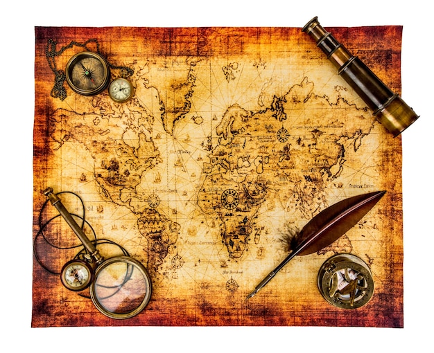 Vintage magnifying glass, compass, goose quill pen, spyglass and a pocket watch lying on an old map isolated on white.