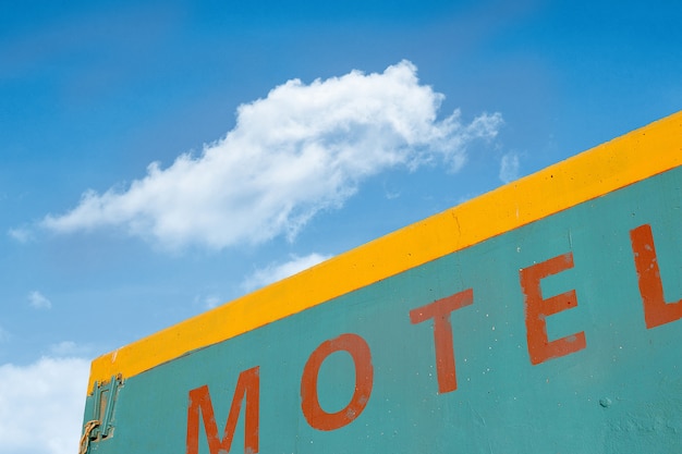 Vintage motel building with white cloud and blue sky