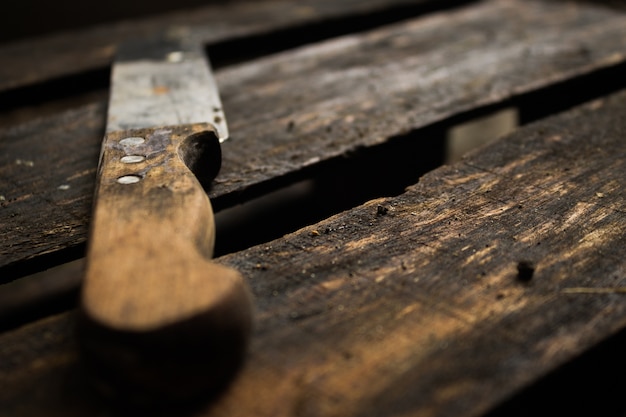 Vintage old rusty knife on wooden background