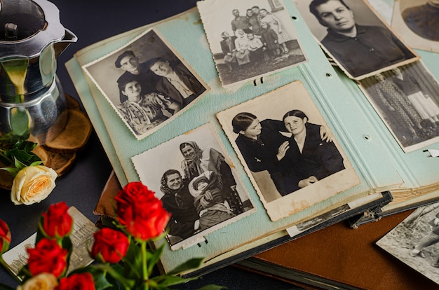 Vintage photo album with family photos. Life values and generations concept.