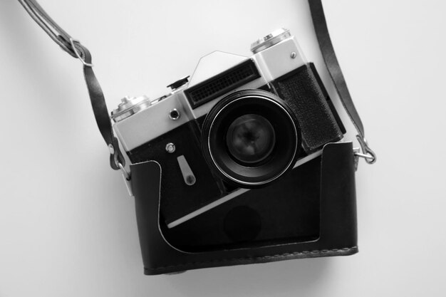 Vintage photo camera on white table