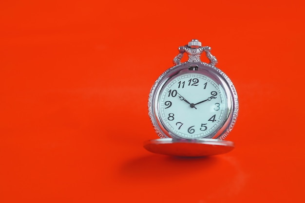 Vintage pocket watch on color background.