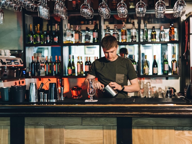 Vintage portrait of bartender creating cocktails at bar Close up of alcoholic beverage preparation