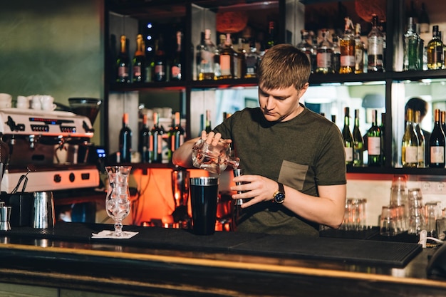 Vintage portrait of bartender creating cocktails at bar Close up of alcoholic beverage preparation