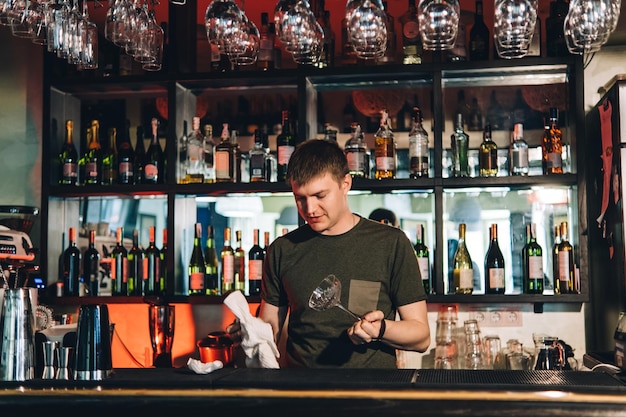 Vintage portrait of bartender creating cocktails at bar Close up of alcoholic beverage preparation