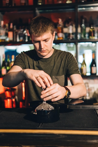 Vintage portrait of bartender creating cocktails at bar Close up of alcoholic beverage preparation