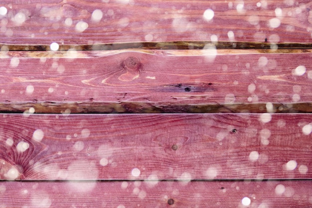 Vintage red wooden table with snow background