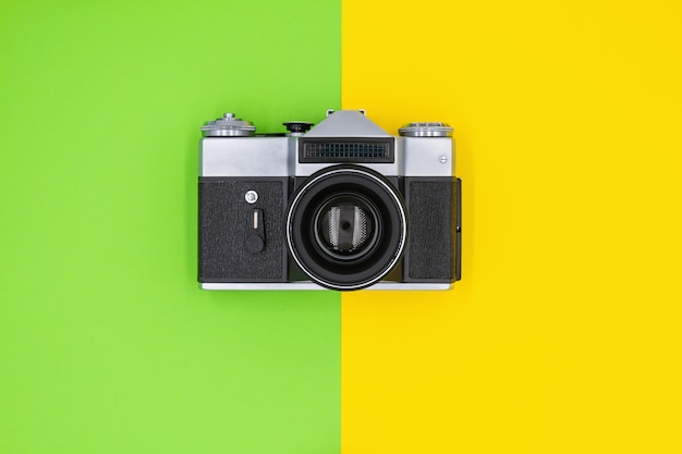 Vintage retro camera on a colored background