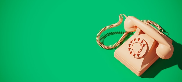 Vintage rotary telephone on green background