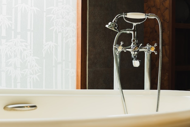 Vintage silver hot and cold faucet at bath basin in luxury hotel.