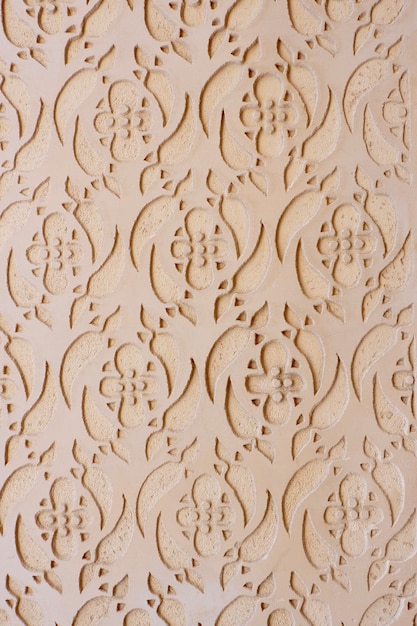 Vintage stucco ornate of beige colour on the wall outside on the street of Segovia Spain